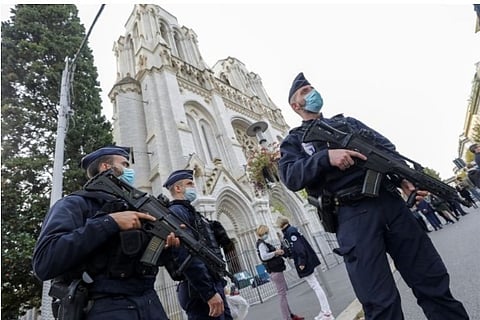 Source: Reuters; Police officers stand near Notre Dame church