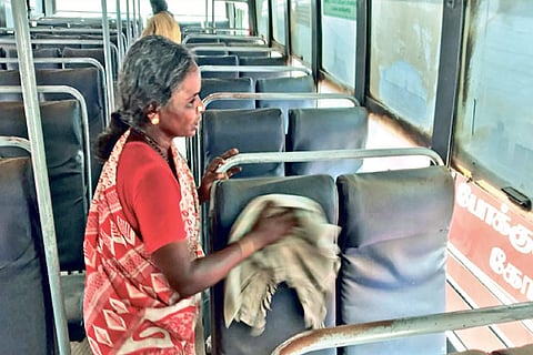 A worker cleans a bus a day ahead of services resumption at Pollachi