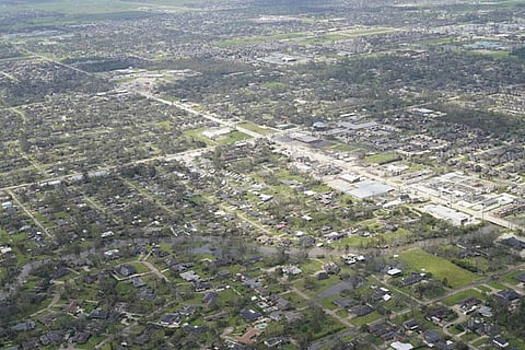 Blown down trees and debris surround damaged homes and buildings in the aftermath of Hurricane Laura