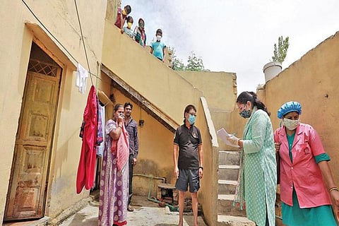 School teachers conduct a door-to-door survey to detect Covid-19 cases at Mahipalpur in New Delhi