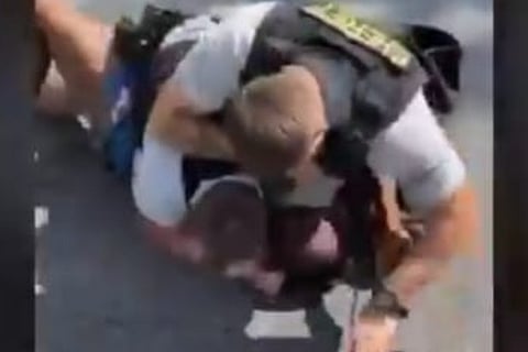 US cop on leave after 'pinning, punching' black man