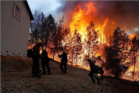 File photo: Reuters;cooler, damp weather have aided the fire fighters in their battle