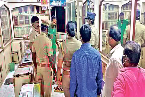 Cops, forensic experts inspect the crime scene
