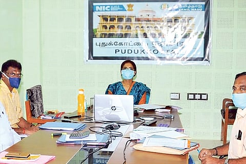 District administration meeting with banner in Hindi and English