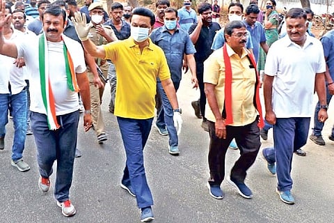 DMK leader MK Stalin flanked by residents during a morning walk in the Race Course area.