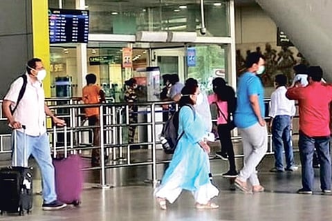 Passengers arrive at the city airport on Saturday