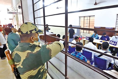 A security guard watches the voting at Velachery booth