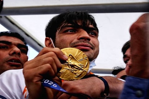 Neeraj Chopra with his gold medal crowded with enthusiastic fans (Image source: IANS)