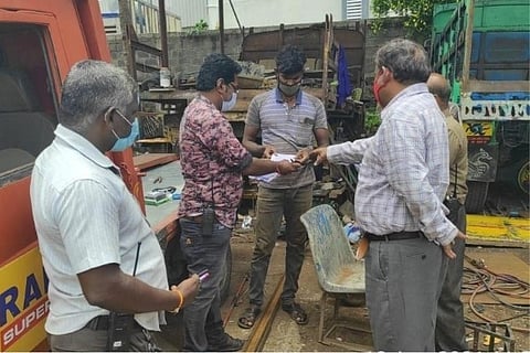Caption: Officials collect the penalty amount from an individual who dumped garbage in Perungudi lak