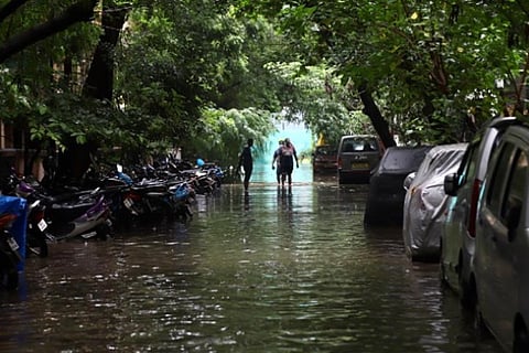People passing through a flooded street in Chennai (File Photo)