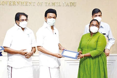 Stalin handing over Rs 50,000 ex-gratia to the kin of a COVID victim in Chennai on Wednesday
