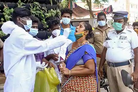 A medic collects a swab sample from a person for Covid-19 testing (Image: PTI)