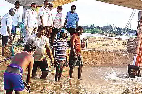 Vellore Corporation workers searching for damaged pipes in Ponnai river