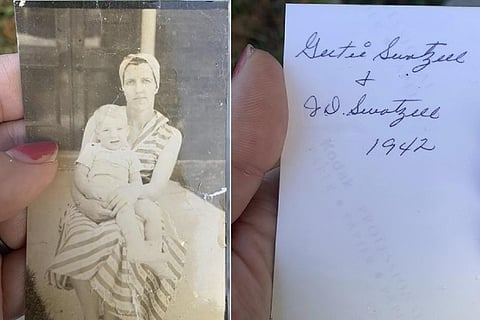 Katie Posten holding a photograph she found stuck to her car's windshield