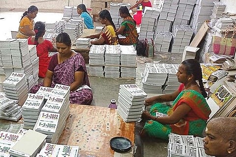 Workers packing printed calendar sheets at a unit in Sivakasi