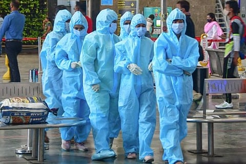 Healthcare workers at the Bengaluru airport (Image credit: PTI)