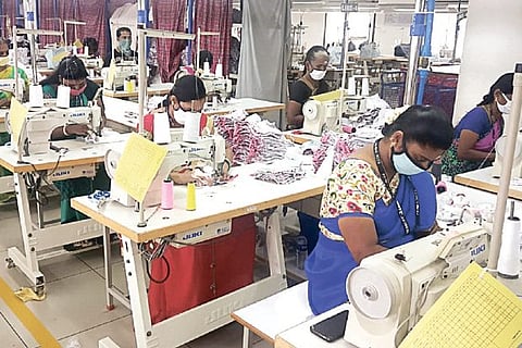 Workers producing garments at a manufacturing unit in Tirupur.