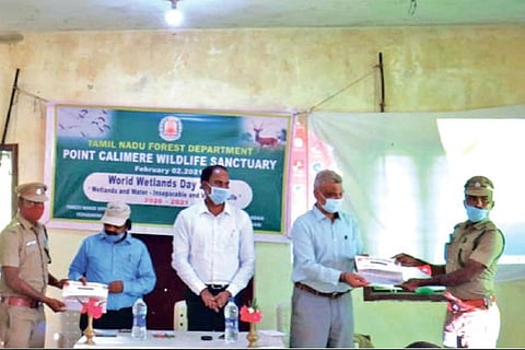 Forest Department officials distribute field books on Indian birds to foresters