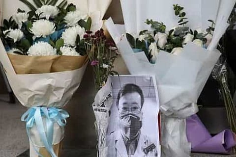 A makeshift memorial for Li Wenliang, a doctor who issued an early warning about the covid outbreak