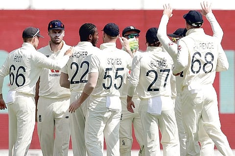 England players celebrate the fall of a India wicket