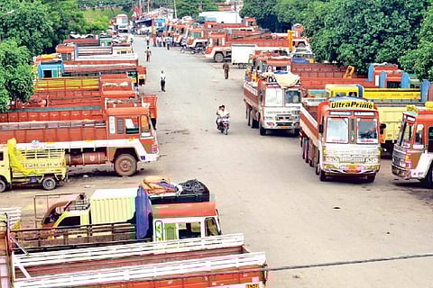 Lorries parked at a yard in view of the strike in Coimbatore on Friday