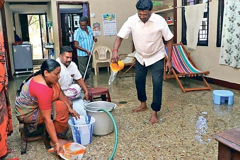 A family cleaning the house after draining out the rainwater