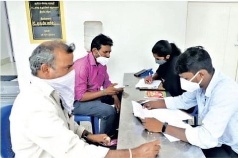 Volunteers from Kadal helping parents fill application forms