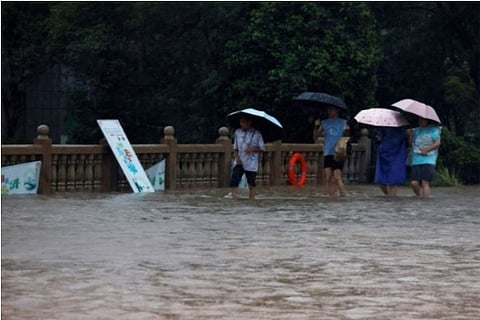Heavy pours floods a bridge in Hebi, Henan Province (Credit: Reuters)