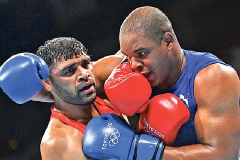 Satish Kumar (in red) in action against Ricardo Brown