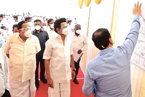 An official explaining the details of Mettur dam to Chief Minister Stalin