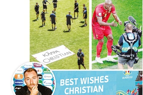 (clockwise) Sweden players train next to a banner displaying a message in support of Christian Eriks