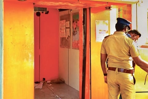 Police investigating at the looted ATM kisok in Tirupur on Sunday