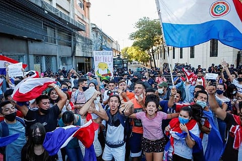 Fire, smoke, gunshots in Paraguay capital as pandemic response ignites protests