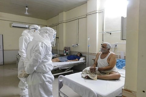 Chief of Defence Staff Gen Bipin Rawat during his interaction with a covid patient (Photo: ANI)
