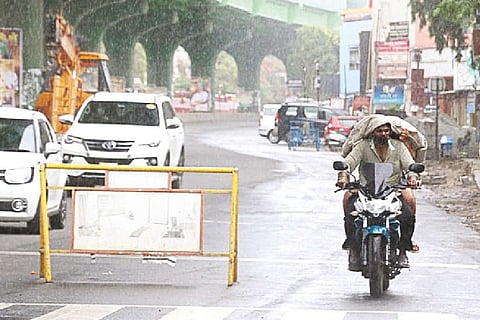 Motorists venturing out as intensity of the rains came down in Coimbatore on Sunday.