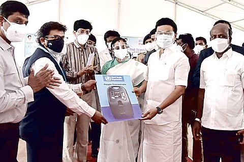 WHO representatives in India Dr KN Arun Kumar and Dr K Surendran presenting 100 oxygen concentrators