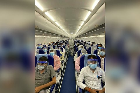 Passengers in a flight with all Covid-19 precautions being carried out