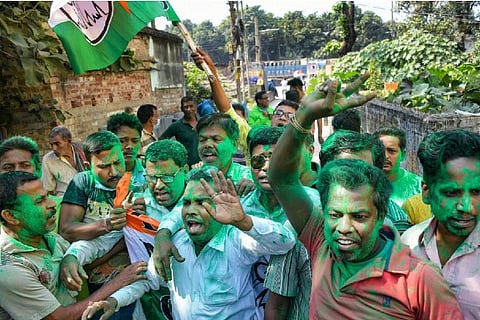 Trinamool Congress (TMC) activists celebrate as the party is leading during the counting of votes of