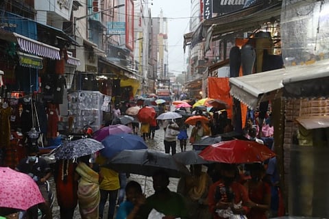 People wade through TNagar despite heavy rainfall on Sunday (Photo: Manivasagan)