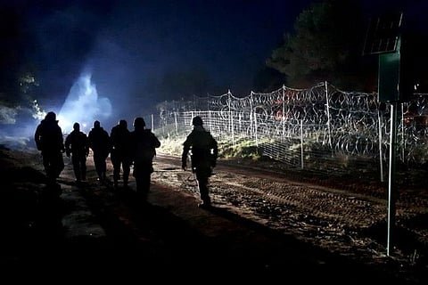 Polish soldiers patrol Poland/Belarus border near Kuznica, Poland (Image credit: Reuters)
