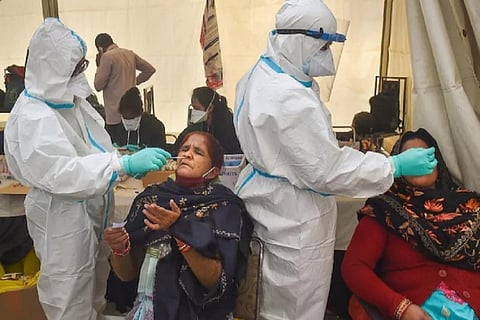 Healthcare workers collect sample from people (File Photo)