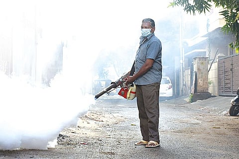 A GCC worker using the mosquito eradication machine.