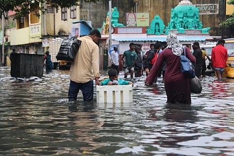 People wading through a flooded road in Chennai (Photo: Manivasagan)