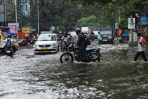 Vehicles plying through an inundated road. Photo: Justin