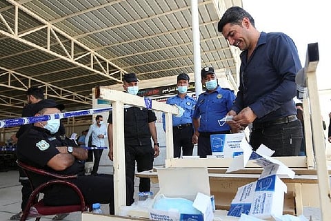 Protective measures undertaken outside the polling booth. Image Courtesy: Reuters