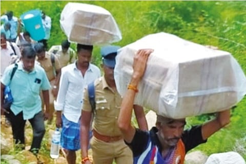 Polling materials being carried to a hill hamlet in Namakkal on Friday