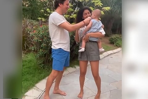 Screengrab of Shriya Saran and her husband with their baby.