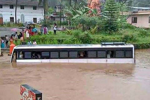 A bus partially submerged on a waterlogged road following heavy rains at Poonjar in Kottayam