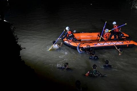 Rescuers search for victims of drowning in a river in Ciamis, West Java, Indonesia (Image credit: AP
