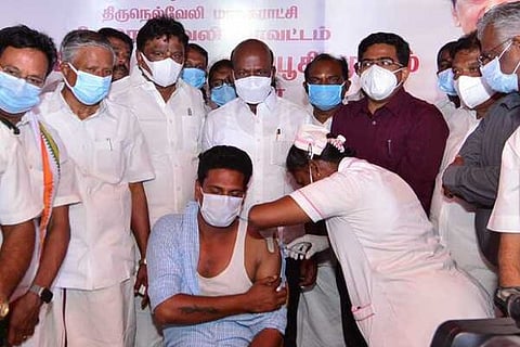 A man gets vaccinated in one of the camps